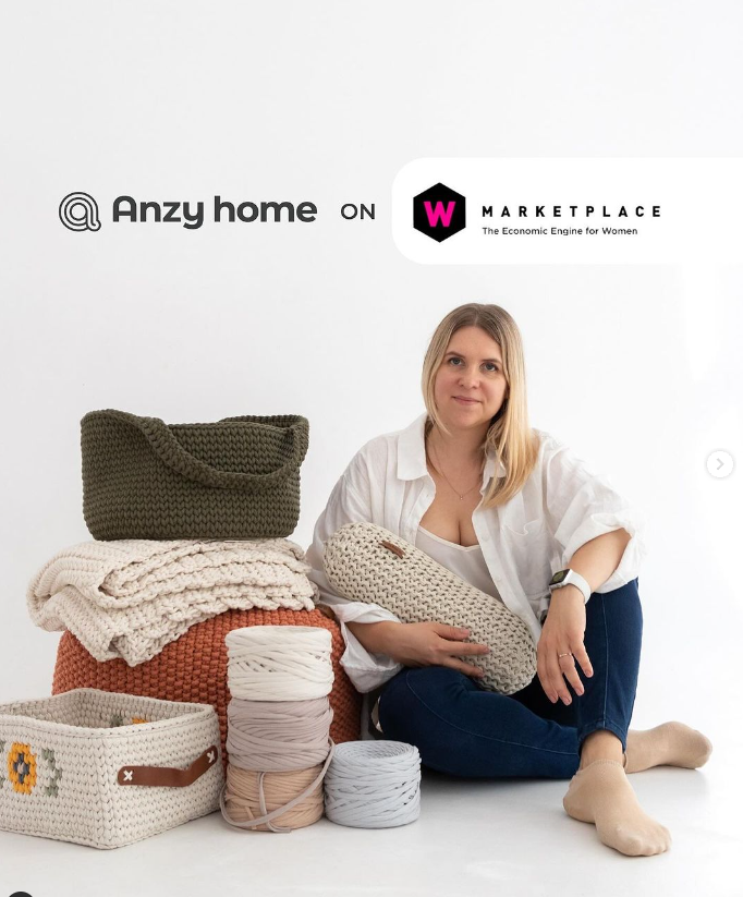 A person sitting on the floor with a pile of yarn

Description automatically generated