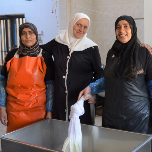 A group of women standing in a roomDescription automatically generated