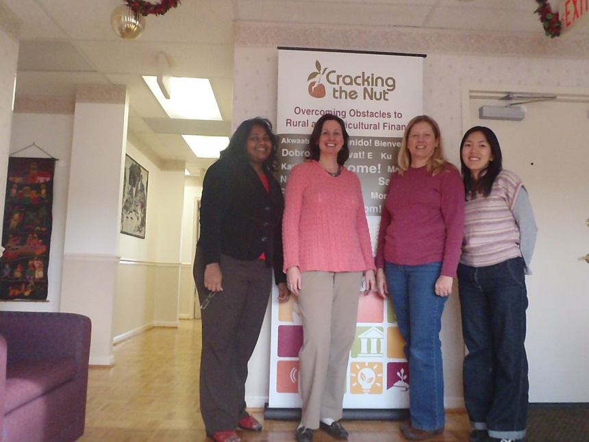 A group of women standing in front of a signDescription automatically generated